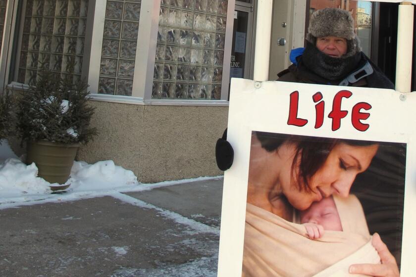 An abortion protester outside the Red River Women's Clinic in Fargo, N.D., in 2013.
