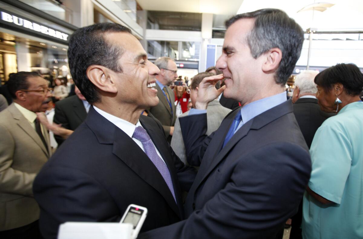 Former L.A. Mayor Antonio Villaraigosa and current L.A. Mayor Eric Garcetti greet each other in Los Angeles in 2013. The two, along with former San Francisco Mayor Gavin Newsom, spoke at a mayors conference in San Francisco on Sunday.