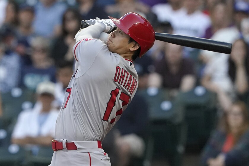 Los Angeles Angels' Shohei Ohtani watches his solo home run during the third inning of the team's baseball game against the Seattle Mariners, Friday, July 9, 2021, in Seattle. (AP Photo/Ted S. Warren)