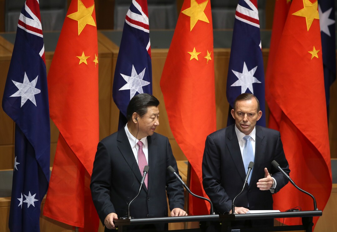 Chinese President Xi Jinping and then-Australian Prime Minister Tony Abbott speak at a press conference