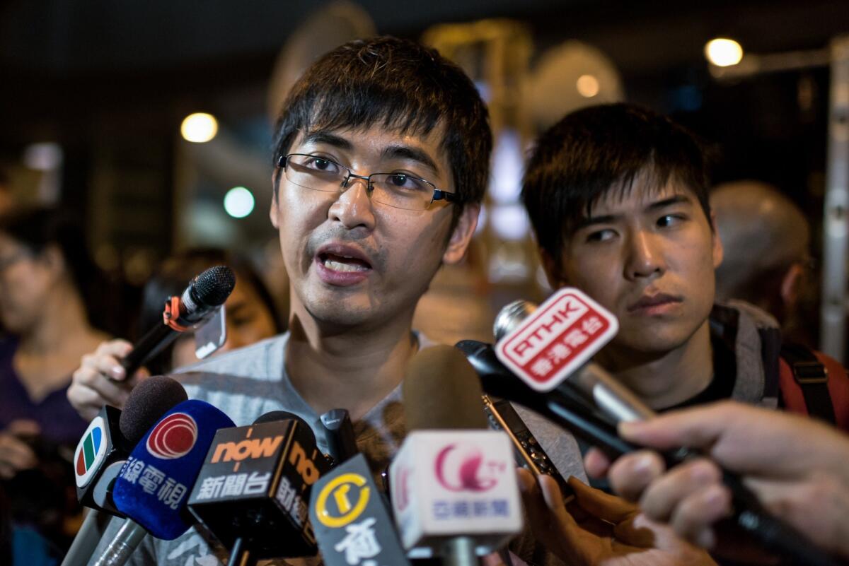 Hong Kong student leader Alex Chow speaks to the media at a pro-democracy protest outside government offices last week.
