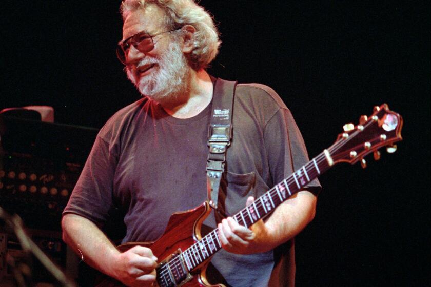 FILE--This Nov. 1, 1992 file photo shows Grateful Dead lead singer Jerry Garcia performing in Oakland , Calif. Garcia, who died on Aug. 9, 1995, Cyndi Lauper and Toby Keith will be inducted into the Songwriters Hall of Fame in June. The organization announced Wednesday that Linda Perry, country music songwriter Bobby Braddock and Hoochie Coochie Man writer Willie Dixon will also be inducted on June 18. (AP Photo/Kristy McDonald, File)