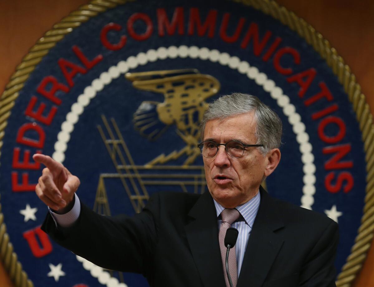 FCC Chairman Tom Wheeler, shown at a roundtable discussion in Washington, D.C., in September, addressed net neutrality rules, spectrum auctions and other contentious issues during a question-and-answer session at the Consumer Electronics Show in Las Vegas on Wednesday.