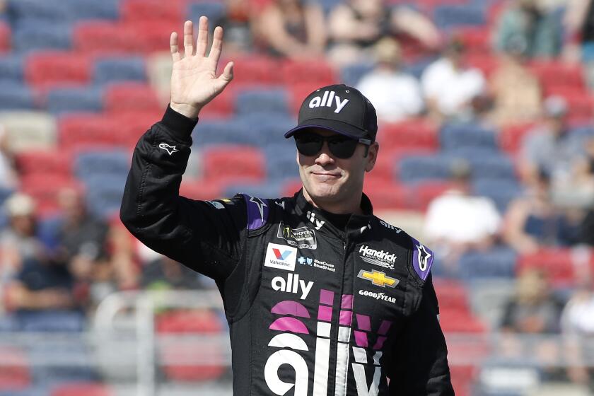 FILE - In this Nov. 10, 2019, file photo, Jimmie Johnson waves during driver introductions prior to the NASCAR Cup Series auto race at ISM Raceway in Avondale, Ariz. Seven-time NASCAR champion Jimmie Johnson says 2020 will be his final season of full-time racing. The winningest driver of his era will have a 19th season in the No. 48 Chevrolet and once again chase a record eighth championship. Johnson made the announcement in a video posted on social media, Wednesday, Nov. 20, 2019. (AP Photo/Ralph Freso, File)