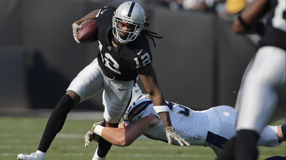 Oakland Raiders wide receiver Martavis Bryant (12) runs against Chargers linebacker Kyle Emanuel during the first half.