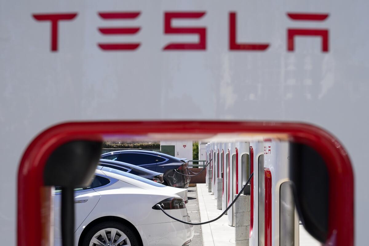 Tesla vehicles charge at a station in Emeryville, Calif., in 2022. 
