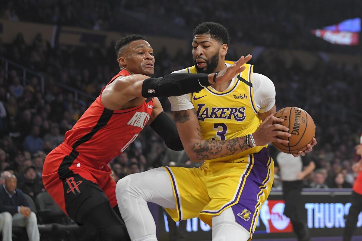 Lakers forward Antonio Davis tries to score inside against Rockets guard Russell Westbrook during a game Feb. 6, 2020.
