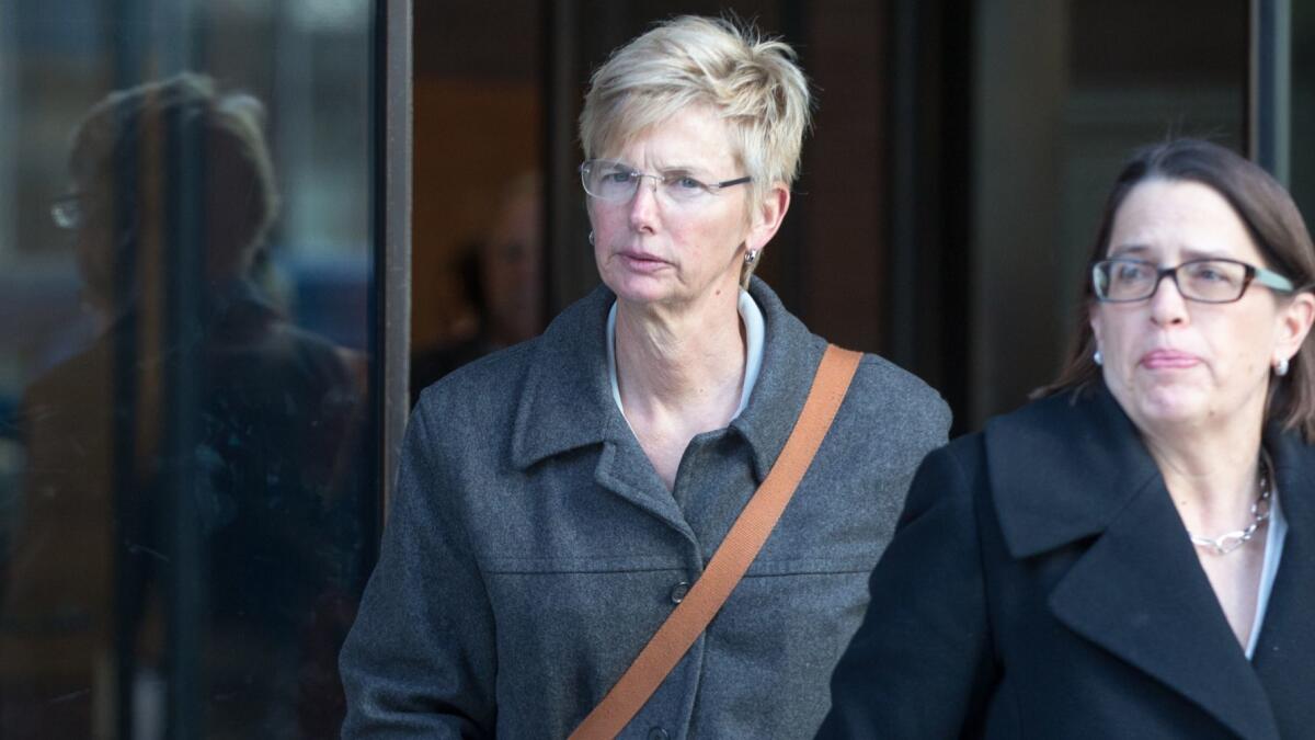 Former USC senior associate athletic director Donna Heinel, left, leaves a Boston courthouse following her arraignment on March 25.