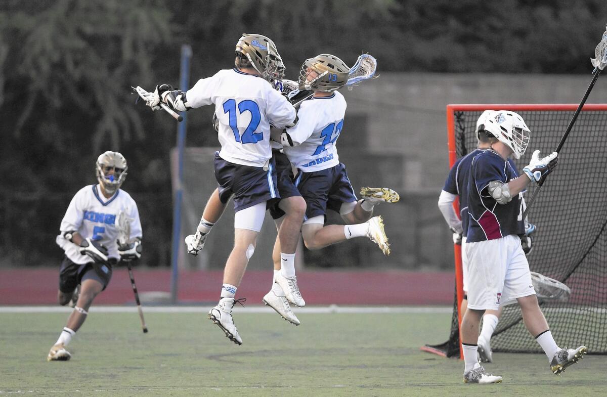 Corona del Mar High's Stephen Von der Ahe (12) and Ryan Meckler celebrate the game's first goal seconds into the game against St. Margaret's in the U.S. Lacrosse Southern Section South Division finals at Trabuco Hills High on Wednesday night.