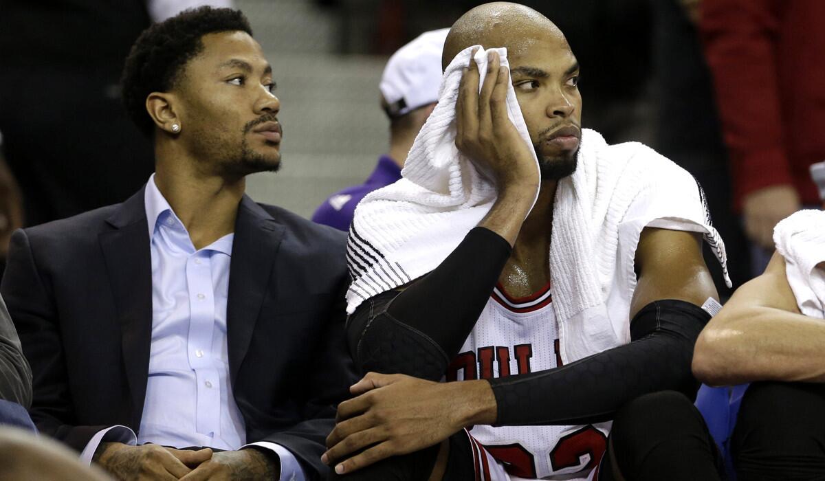 Derrick Rose, left, and Taj Gibson watch the closing moments of the Chicago Bulls 103-88 loss to the Kings in Sacramento on Nov. 20.