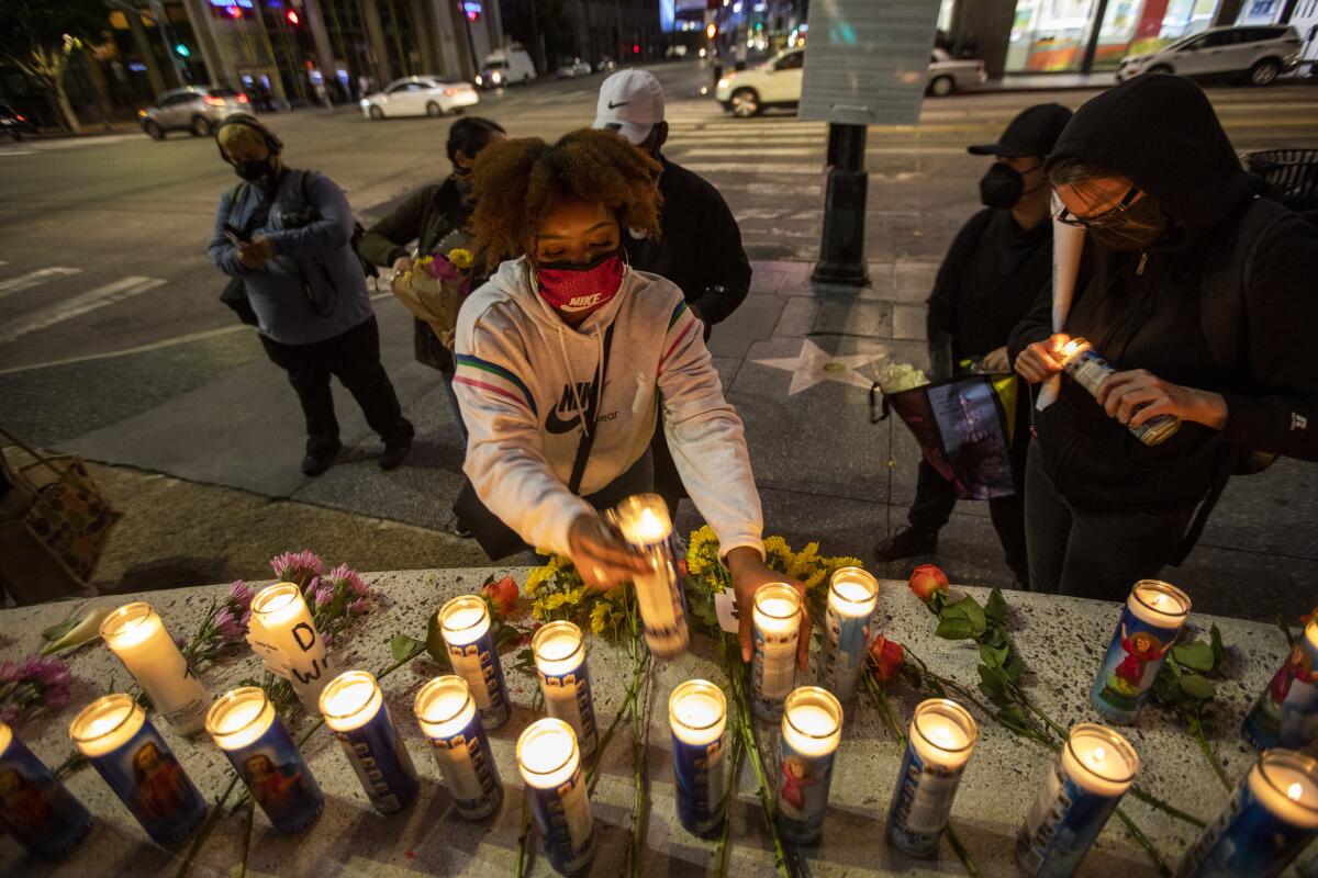  Angela Hall, 28, lights candles in Hollywood, CA. 