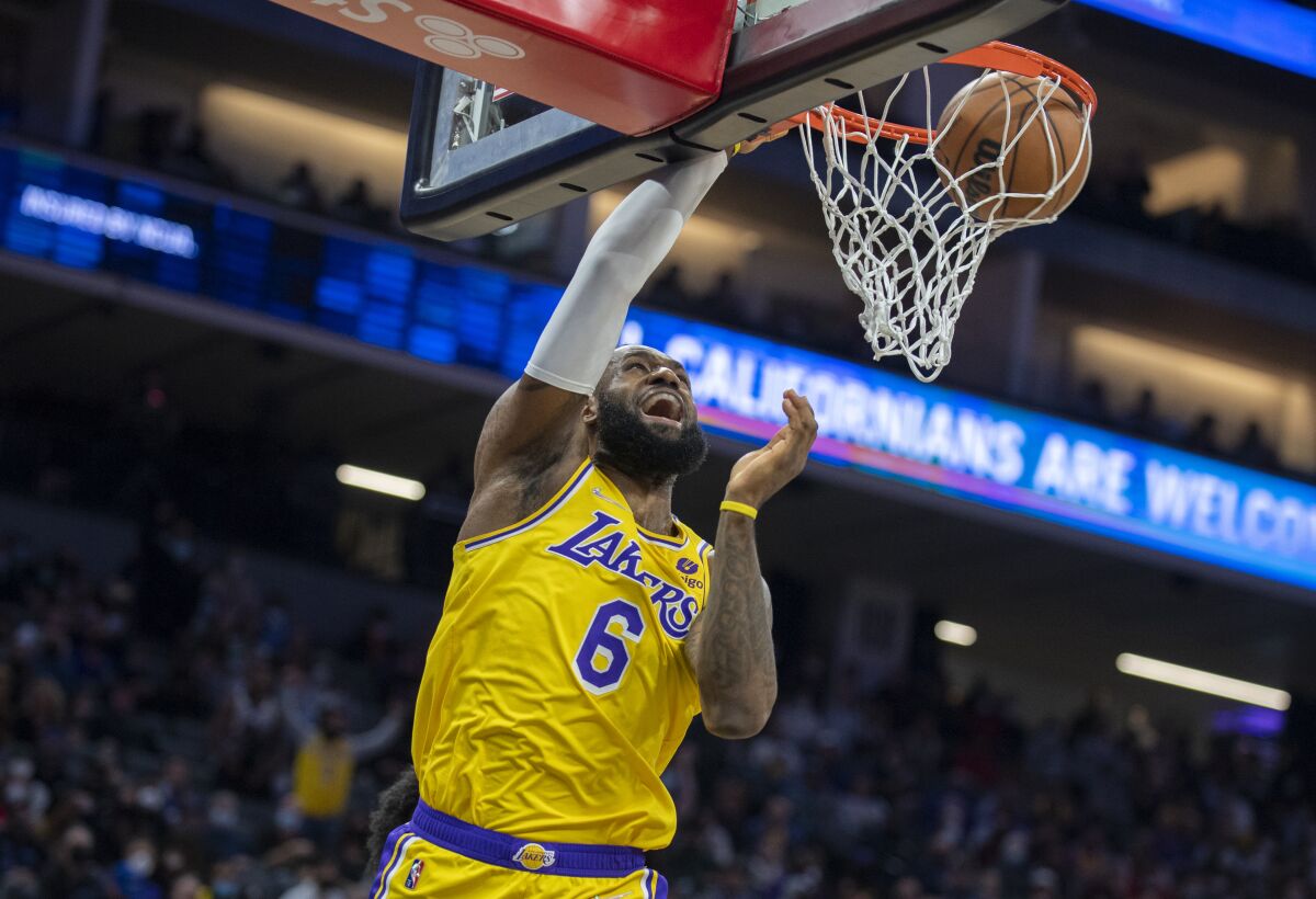 Lakers star LeBron James dunks during the first quarter of a loss to the Sacramento Kings on Wednesday.