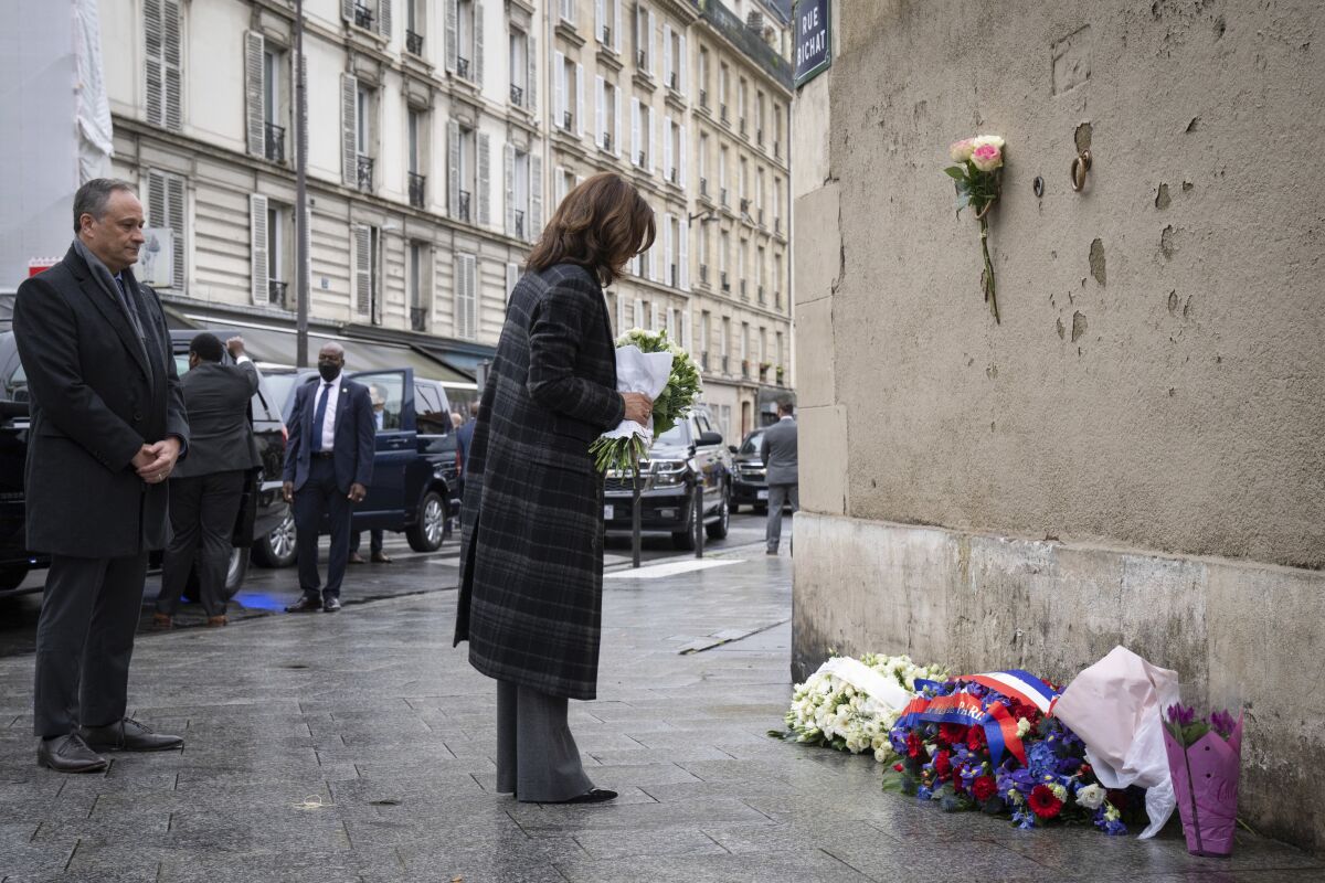 Vice President Kamala Harris lays flowers to honor the victims of the attack on Paris at the Carillon Café in Paris, France, Saturday, Nov. 13, 2021. On Nov. 13, 2015, a series of coordinated terrorist attacks occurred through Paris killing a total of 130 people, 13 at Le Carillon and Le Petit Cambodge cafes. (Sarahbeth Maney/The New York Times via AP, Pool)