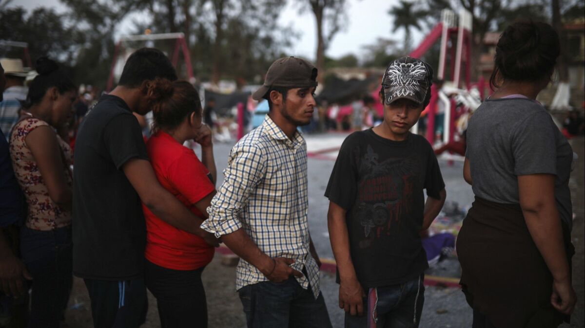 Central American migrants in a caravan stand in line to start their documentation with a Mexican immigration official in Matias Romero, Oaxaca state, Mexico on April 2.