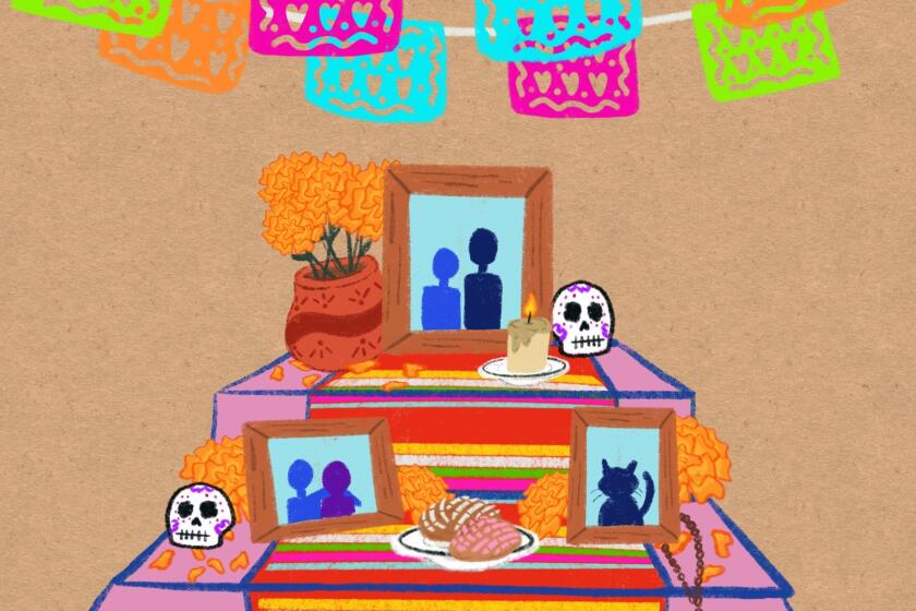 Papel picado above a Día de Muertos altar 