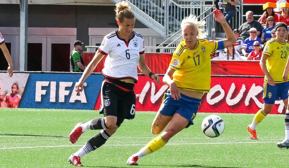 Germany's Simone Laudehr, left, battles for the ball against Sweden's Caroline Seger during the FIFA Women's World Cup round of 16 match on June 20. Germany won, 4-1, and will play France in the quarterfinals.