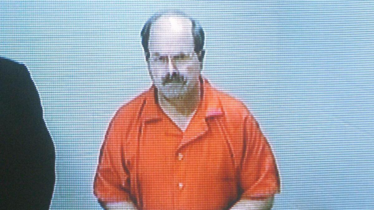Dennis Rader, the BTK killer, during an arraignment in 2005, is working on a book about the murders.