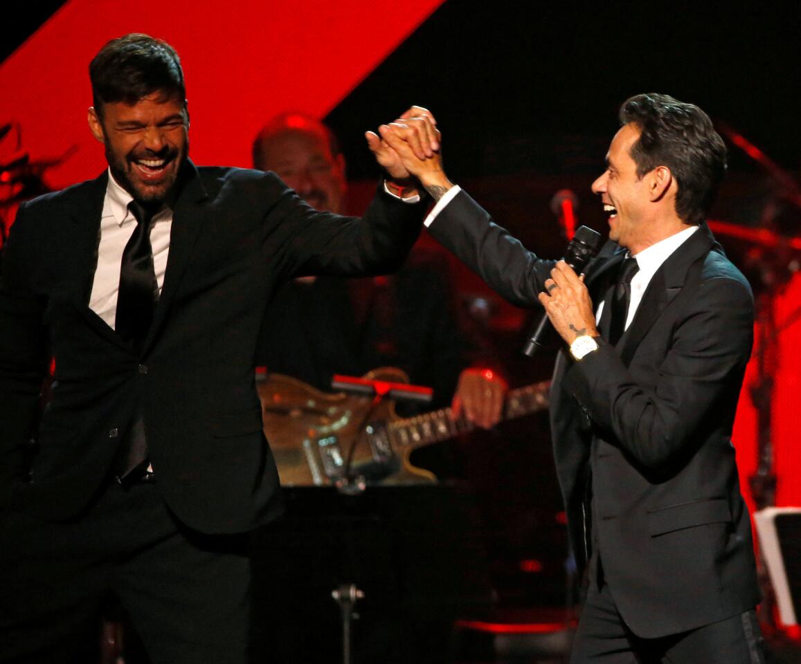 Recording artist Marc Anthony gives a high five to singer Ricky Martin after accepting the Latin Recording Academy Person of the Year award in Las Vegas, Nevada U.S., November 16, 2016. REUTERS/Mario Anzuoni ** Usable by SD ONLY **