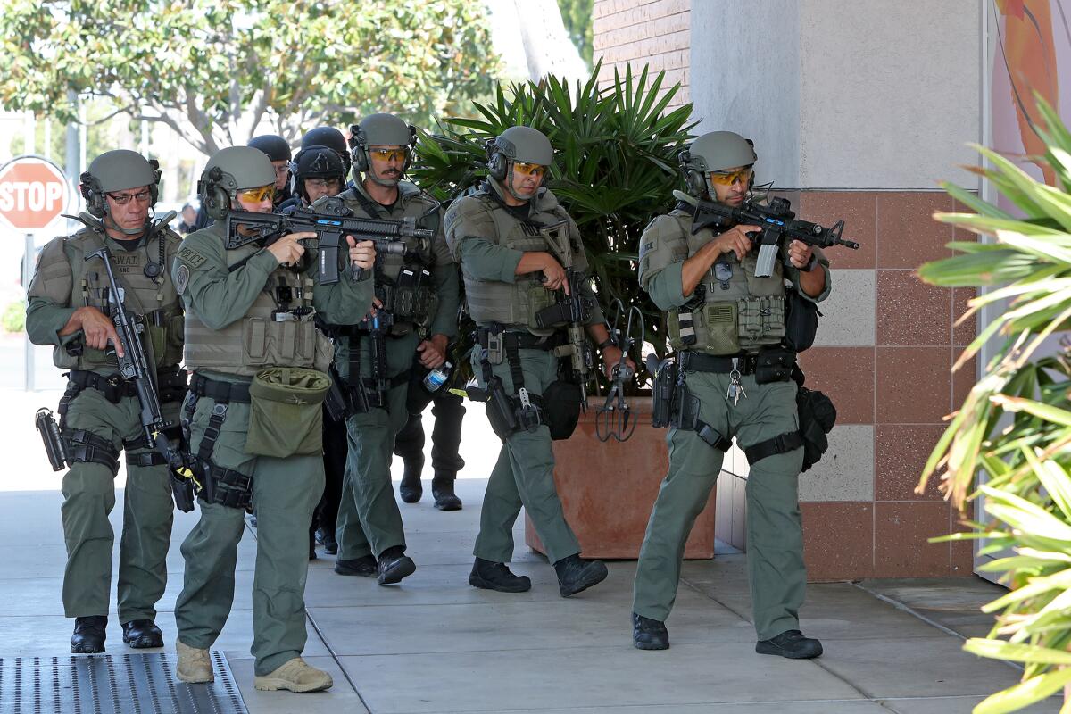 West County SWAT team members draw arms Thursday upon entering the former Sears building at South Coast Plaza for training.