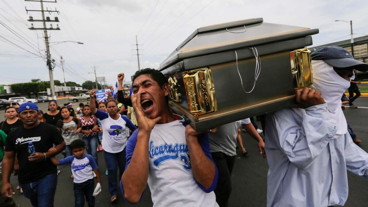 Nicaragua's Roman Catholic Church defended students against government repression during last year's protests. Friends and relatives carry a coffin with the body of a student shot during clashes with police in a church in Managua in July 2018.