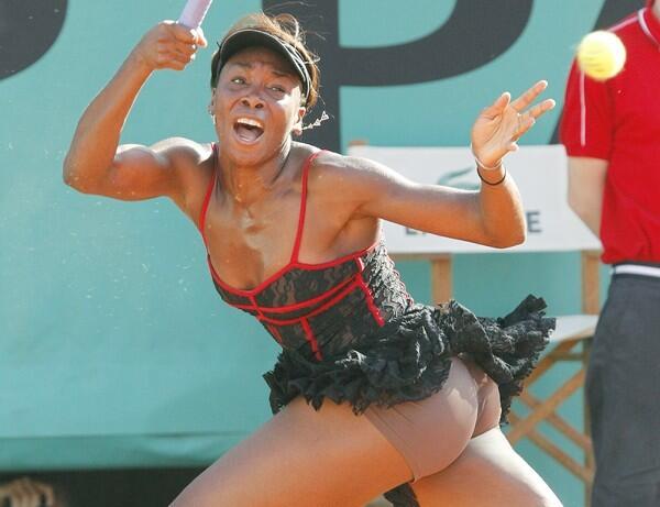 Venus Williams of the US plays a return