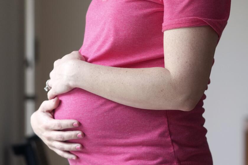 FILE - A pregnant woman stands for a portrait in Dallas, Thursday, May 18, 2023. According to provisional statistics for 2023 released by the Centers for Disease Control and Prevention on Thursday, April 25, 2024, U.S. births fell last year, in a substantial drop marking an apparent end to pandemic-related fluctuations and a return to a long-standing national decline. A little under 3.6 million babies were born in the U.S. last year, about 76,000 fewer than the year before. (AP Photo/LM Otero, File)