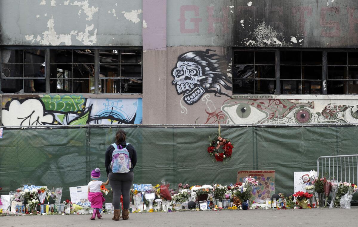 Flowers and other items at the scene of deadly Ghost Ship warehouse fire in Oakland