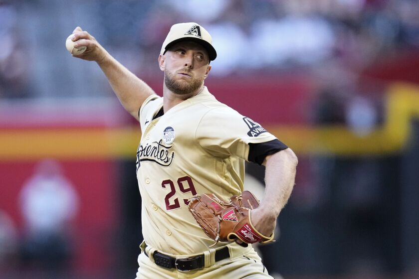 Arizona Diamondbacks starting pitcher Merrill Kelly throws against the Atlanta Braves during the first inning of a baseball game Friday, June 2, 2023, in Phoenix. (AP Photo/Ross D. Franklin)