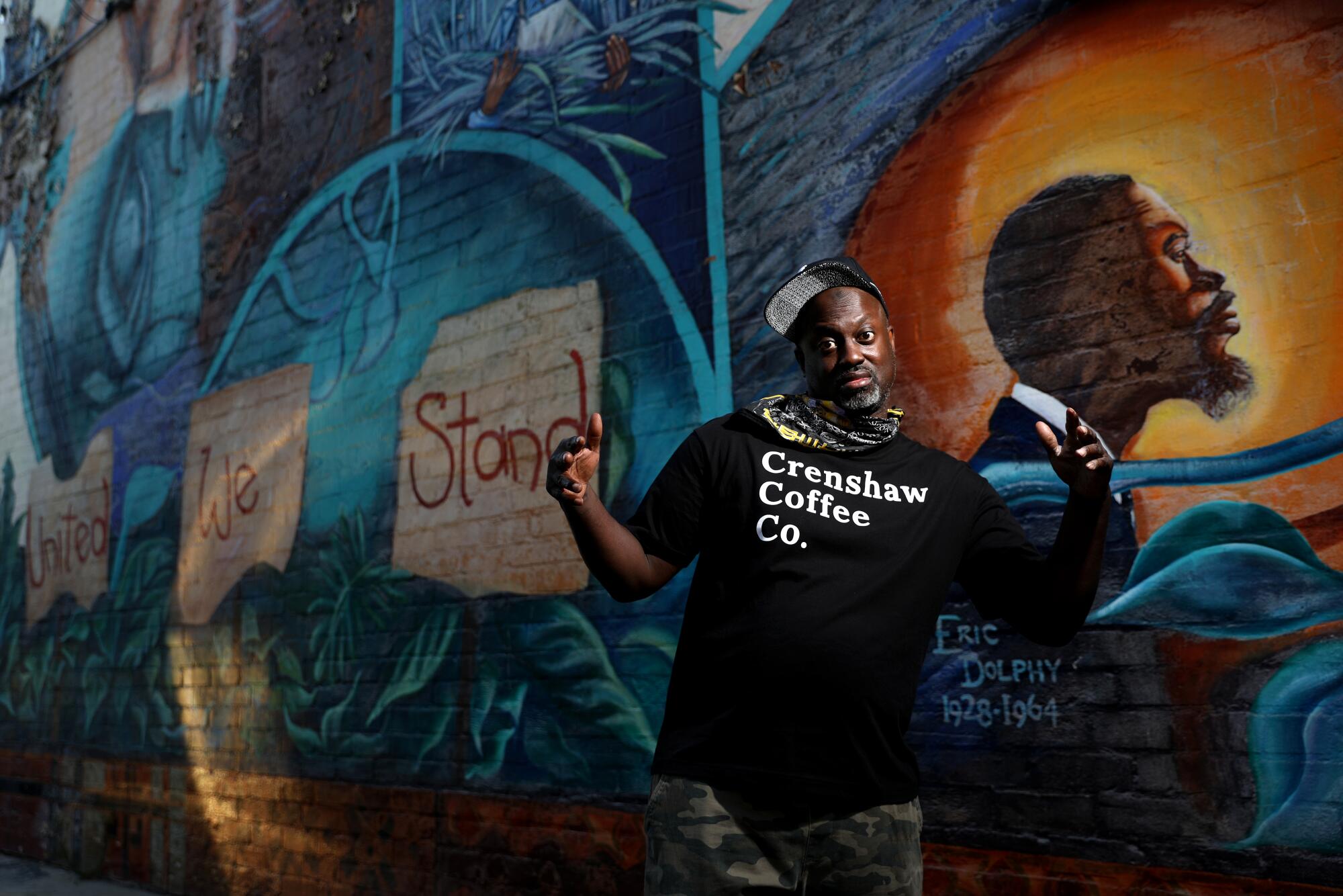 Tony Jolly stands in front of a mural