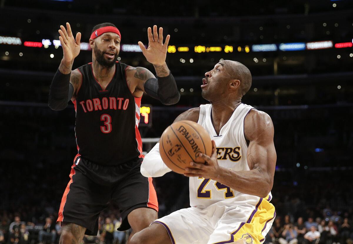 The Lakers' Kobe Bryant pulls up for a jumper against Raptors forward James Johnson during their Nov. 30 game at Staples Center.