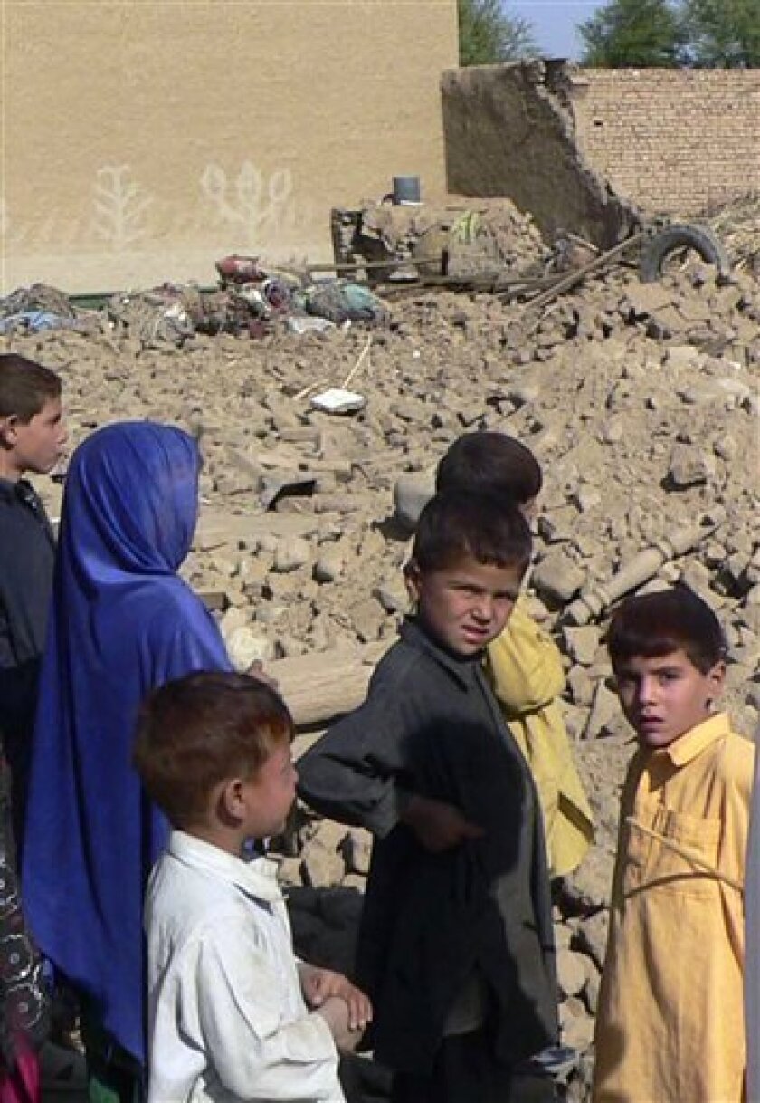 Local children stand beside the rubble of a house hit by suspected U. S. missiles strike in Indi Khel village near Bannu, Pakistan on Wednesday, Nov. 19, 2008. A suspected U.S. missile strike hit a village well inside Pakistani territory Wednesday, officials said, killing six alleged militants and indicating American willingness to pursue insurgents beyond the lawless tribal regions. (AP Photo/Ijaz Muhammad)