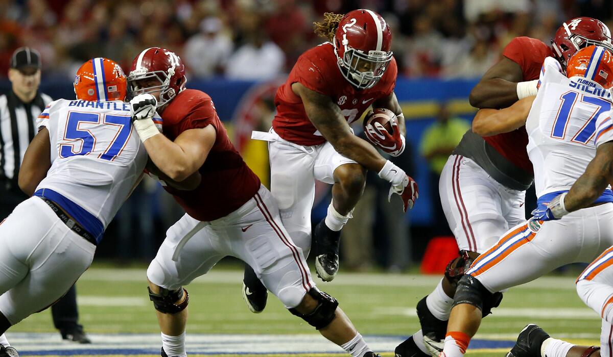 Alabama running back Derrick Henry carries the ball against the Florida Gators in the second quarter during the SEC Championship on Saturday.