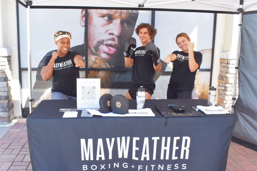 Mayweather Boxing + Fitness instructors TC Mesta and Taylor Foxx with manager Brenna Aho in front of the new studio that will open soon in the 4S Commons Town Center.