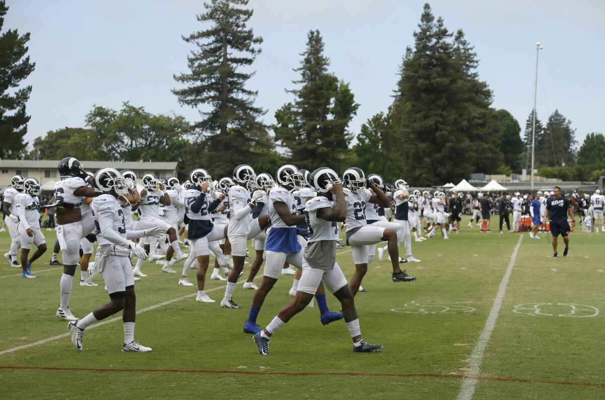 The Rams warm up during training camp. The team will take on the Dallas Cowboys in a preseason game on Saturday in Hawaii.