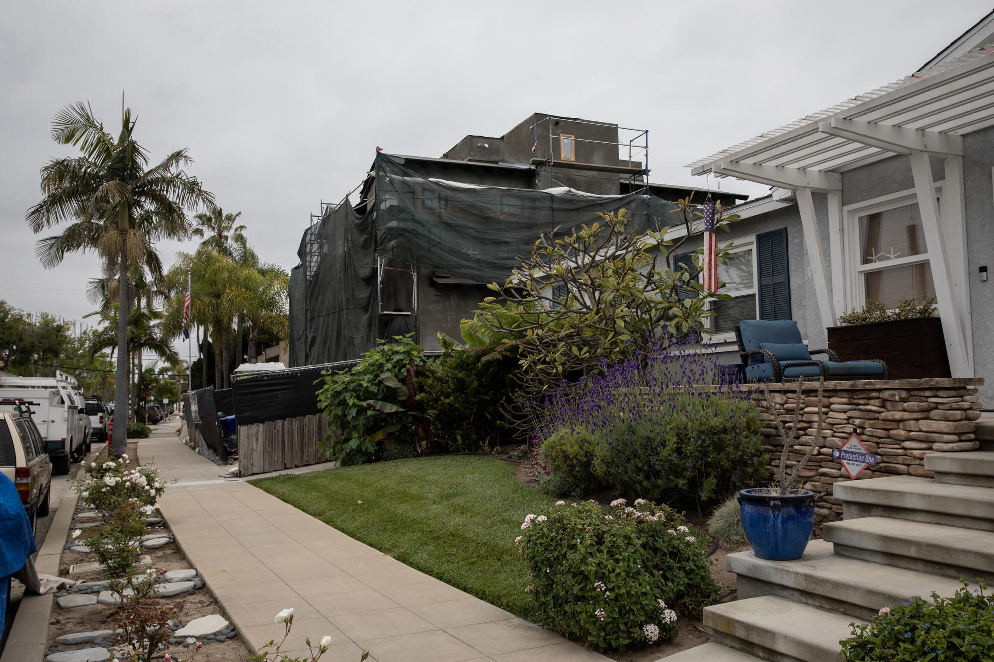 Marc Umemoto, whose home is pictured in the foreground, is fighting his neighbor over the ADU she is building.