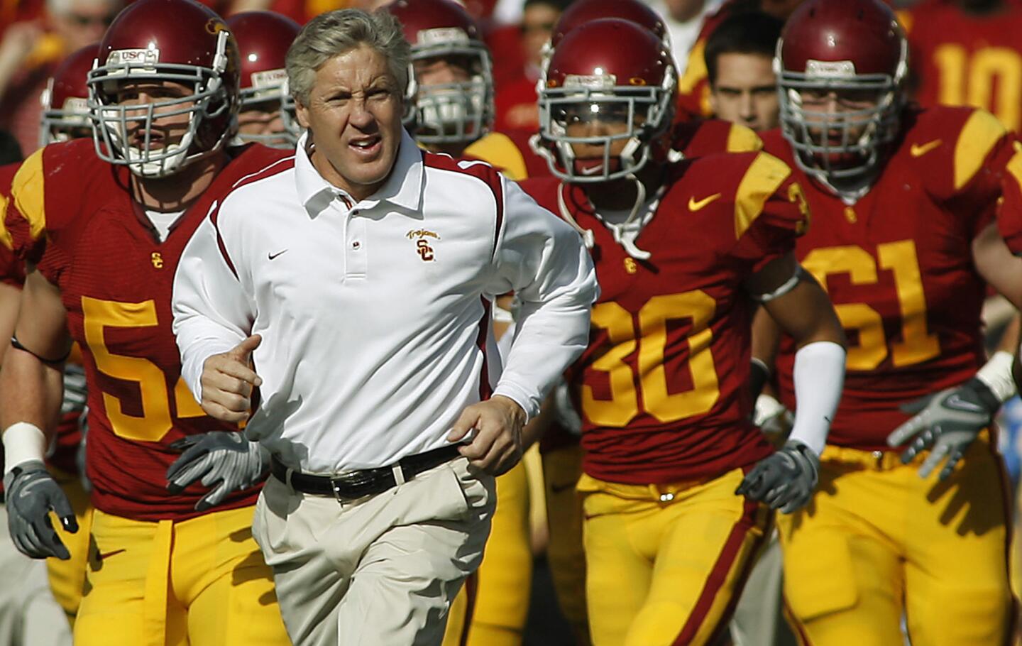 USC Coach Pete Carroll leads the Trojans on to the field for a game against UCLA at the Rose Bowl on Dec. 6, 2008.