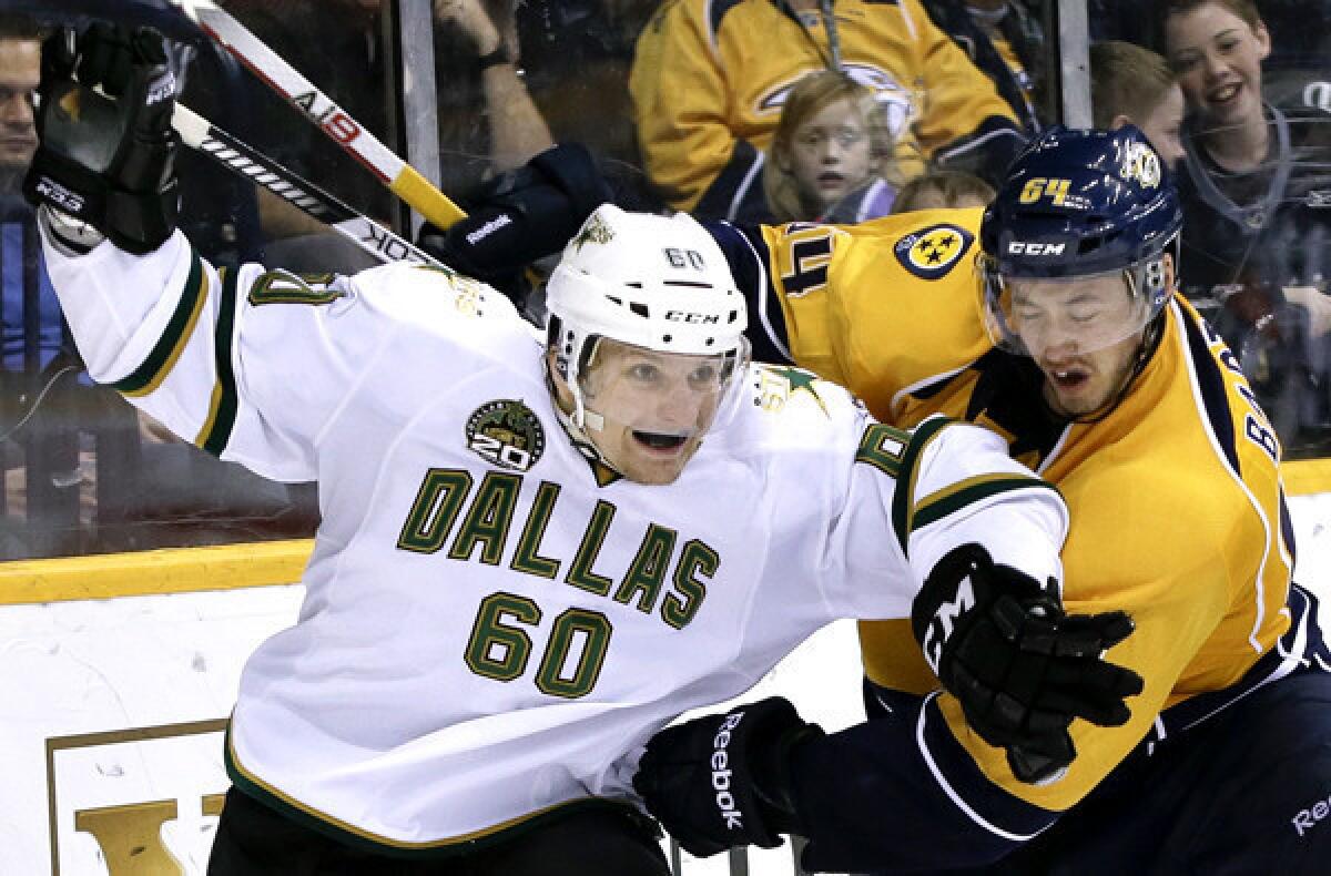 Dallas left wing Antoine Roussel and Nashville defenseman Victor Bartley battle for position in the third period of a game on Friday that the Stars won, 5-2.