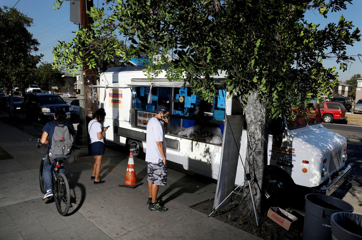 Having food trucks outdoors helped keep Raul Ortega's business, Mariscos Jalisco, alive during the pandemic.