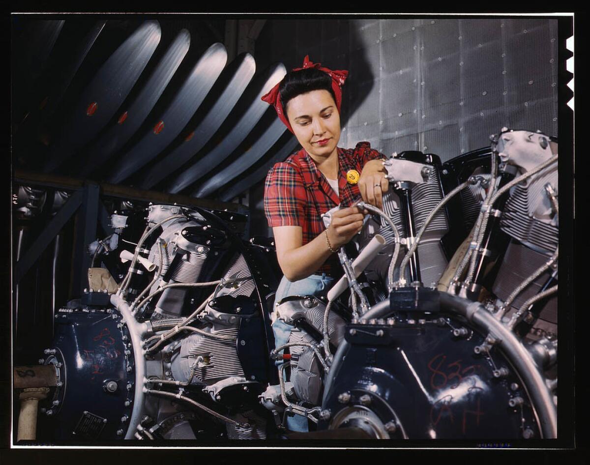 Woman working on an airplane motor at North American Aviation Inc. plant in Inglewood in June 1942.