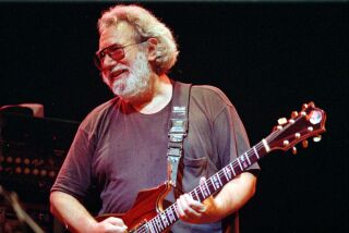 In this Nov. 1, 1992, file photo, Grateful Dead lead singer Jerry Garcia performs in Oakland, Calif. 