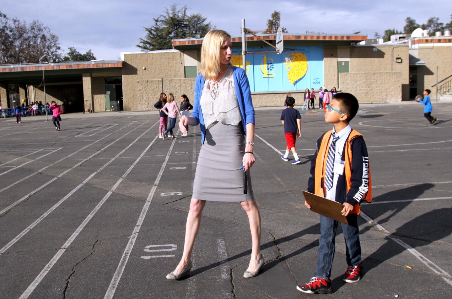La Cañada Elementary School Principal Emily Blaney, left, and the "Principal for a Day" Michael Kwan walk the school yard during recess.