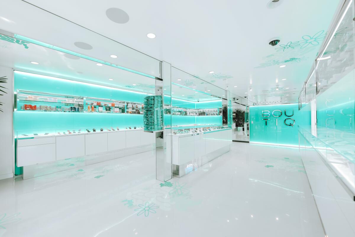 A sleek and spare dispensary interior with white floors and blue walls.