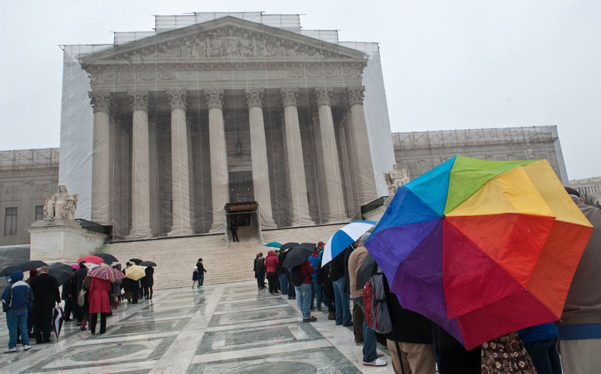 People line up to enter the Supreme Court in Washington. The justices will hear arguments on California's Proposition 8 ban on same-sex marriage on Tuesday and on the federal Defense of Marriage Act, which defines marriage as between one man and one woman, on Wednesday.