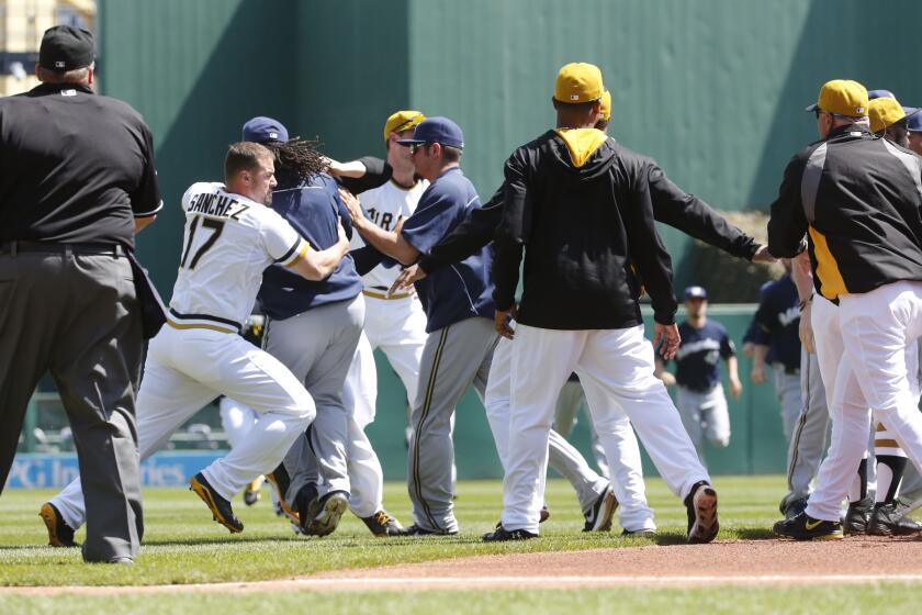 Pittsburgh Pirates and Milwaukee Brewers players fight during the third inning of Sunday's game in Pittsburgh.