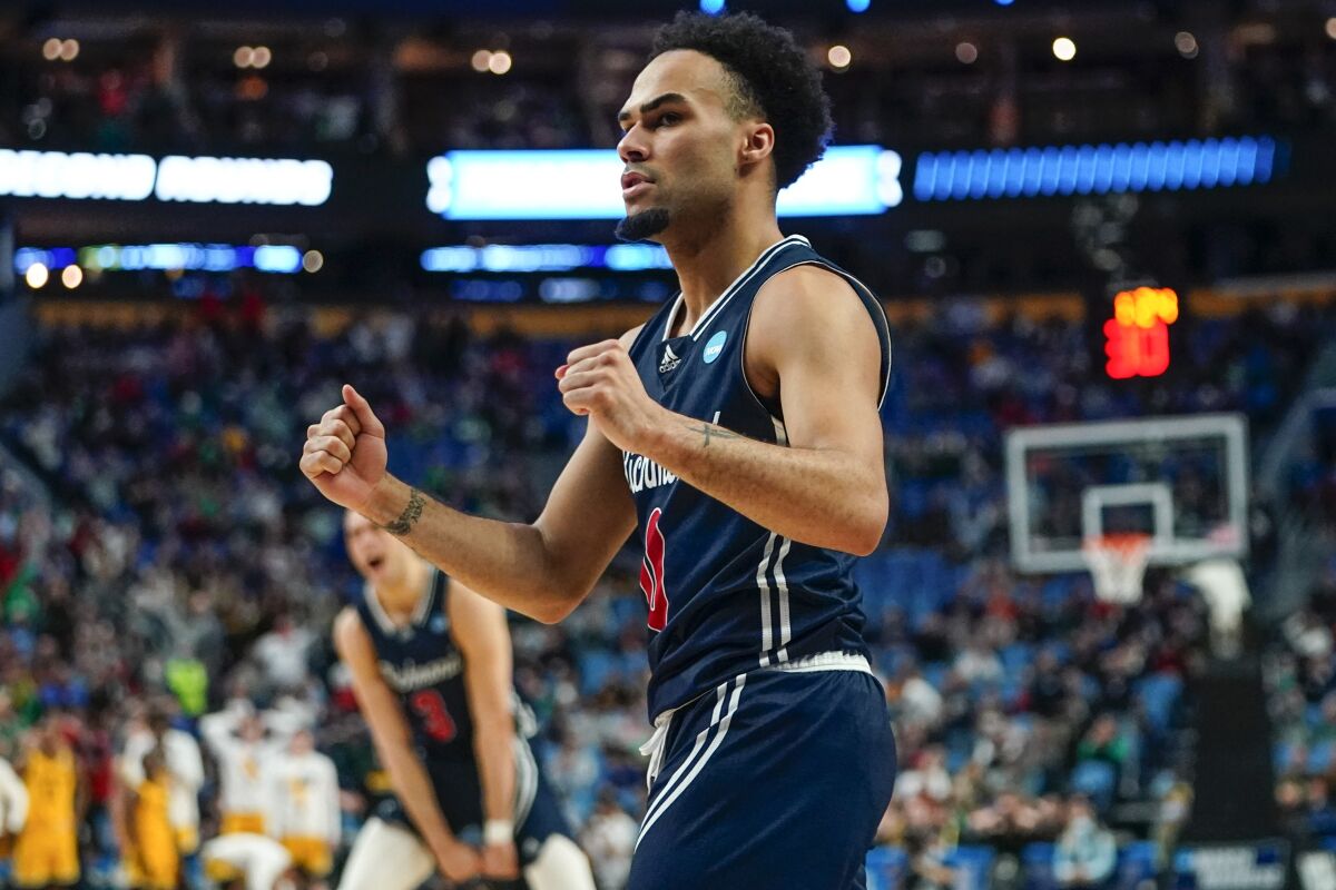 Richmond's Jacob Gilyard (0) celebrates after teammate Nathan Cayo scored in the second half of a college basketball game against the Iowa during the first round of the NCAA men's tournament, Thursday, March 17, 2022, in Buffalo, N.Y. (AP Photo/Frank Franklin II)