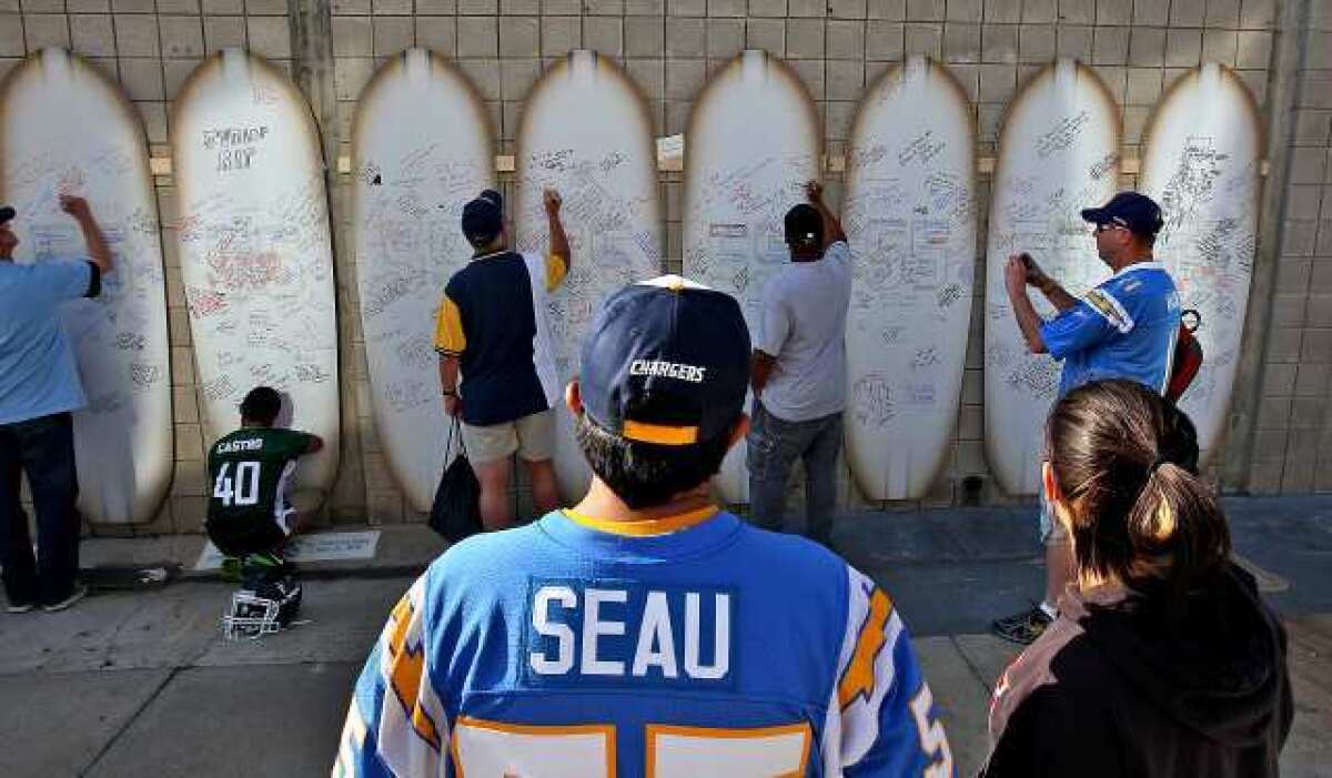 Junior Seau fans leave messages for him on a wall of surfboards at Qualcomm Stadium for a celebration of his life on May 11, 2012.