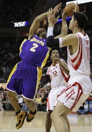 Derek Fisher goes up for a shot as Yao Ming defends.