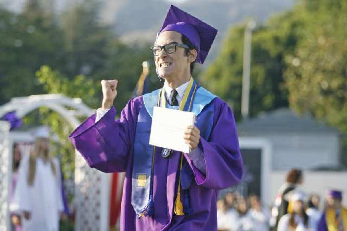Michael Sarkis Yapujian rejoices after receiving his high school diploma during his graduation ceremony at Hoover High School.