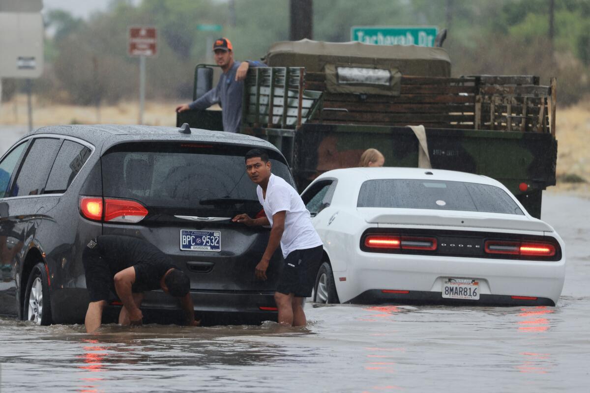 Motorists deal with a flooded road in Palm Springs.