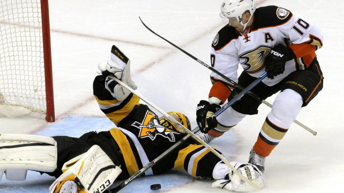 Penguins goalie Marc-Andre Fleury stops a shot by Ducks winger Corey Perry (10) in the first period Saturday.